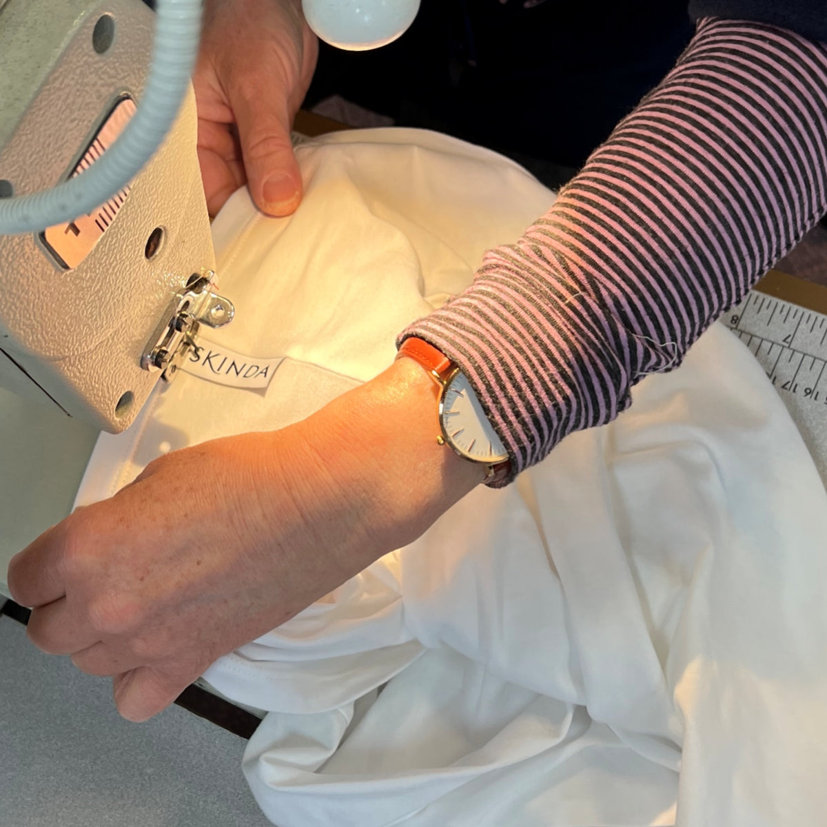 Skinda mens undershirt being stitched by hand